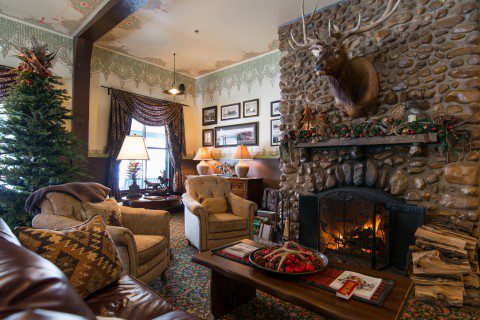 Historic Sheridan Inn's inviting interior lounge with a warm fireplace and Western decor.