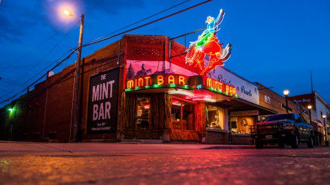The Mint Bar at twilight, a historic watering hole and a must-visit thing to do for nightlife in Sheridan, Wyoming.