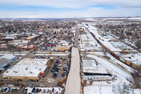 An aerial view of Sheridan, WY, showcasing the town's layout and the skijoring track along its snowy main street.